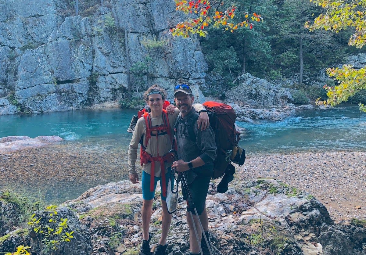 Backpacking crew beside a river