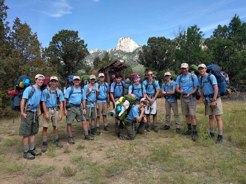Philmont crew gathered near a backcountry landmark
