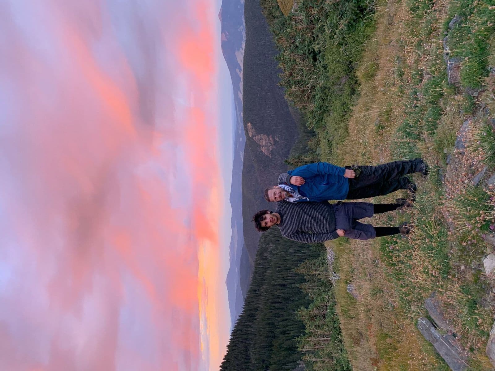 Hikers standing in exposed terrain at sunset